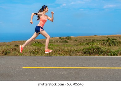 side view photo of professional young female runner player running on road for training personal speed and explosive force at holiday weekend. - Powered by Shutterstock