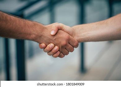 Side View Photo Of Two Men's Handshake Outdoors