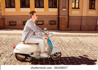 Side View Photo Of Young Man Riding A Motor Bike