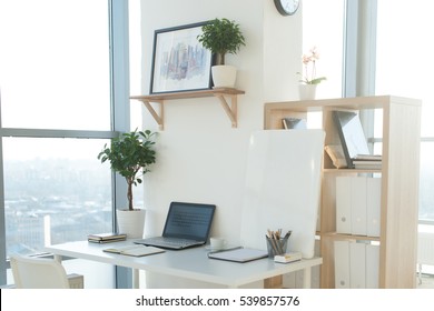 Side View Picture Of Studio Workplace With Blank Notebook, Laptop. Designer Comfortable Work Table, Home Office.