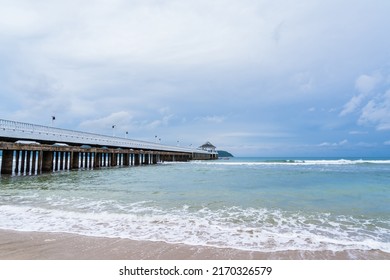 Side View Of Pier At The Beach At Sunset Time.Thailand.