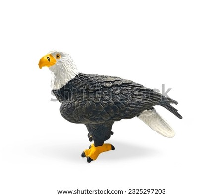 Side view of a plastic bald eagle miniature toy isolated on white