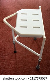 Side View Of A Plastic And Metal Shower Stool For The Disabled