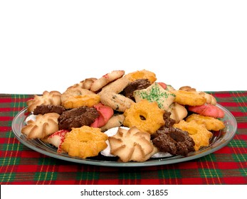 Side View Of A Plate Of Assorted Cookies On A Red And Green Plaid Placemat.