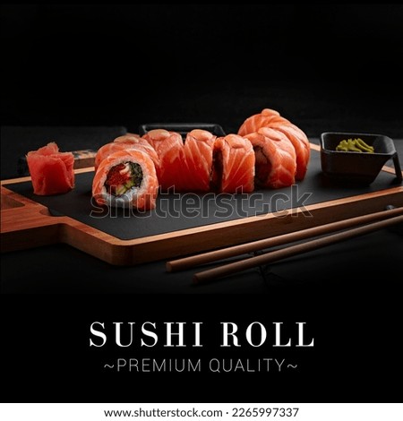 Side view of portion of Japanese sushi roll with caviar, avocado and salmon on top served on wooden board with chopsticks. Dish on black background with text, copy space. Ready advertising banner Stockfoto © 