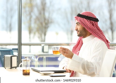 Side View Portrait Of An Arab Man Enjoying A Cup Of Tea In A Coffee Shop