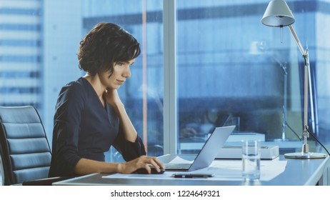 Side View Portrait of the Beautiful Businesswoman Working on a Laptop in Her Modern Office with Cityscape Window View. Female Executive Uses Computer. - Shutterstock ID 1224649321