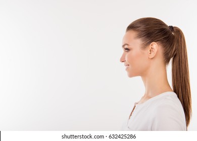 Side view portrait of beautiful woman with ponytail in white t-shirt isolated on white background