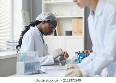 Side View Portrait Of Black Female Scientist Doing Experiments In Medical Laboratory, Copy Space