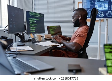 Side View Portrait Of Black Software Engineer Working With Computers In High Technology Office, Copy Space