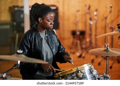 Side View Portrait Of Black Young Woman Playing Drums In Recording Studio And Making Rock Music, Copy Space