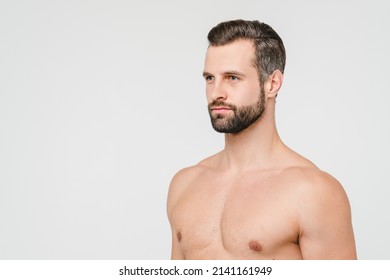 Side View Portrait Of Caucasian Young Handsome Shirtless Naked Man With Beard Isolated In White Background. Male Beauty Body Care Concept