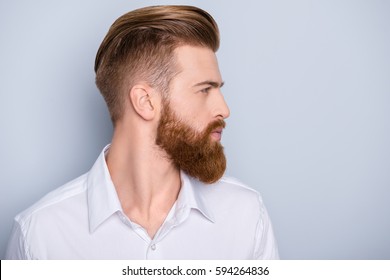 Side view portrait of confident bearded man with beautiful hairstyle   in white shirt looking on copy space - Shutterstock ID 594264836