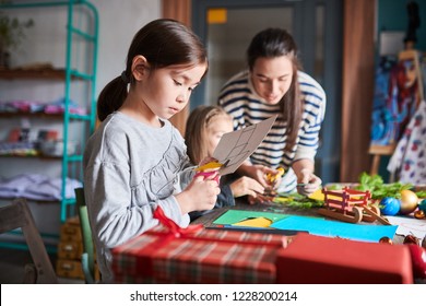 Side View Portrait Of Cute Asian Girl Making Handmade Christmas Gifts In Art And Craft Class, Copy Space