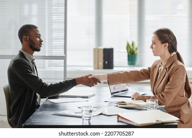 Side View Portrait Of Female Boss Shaking Hands With Candidate In Job Interview, Copy Space