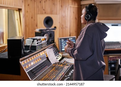 Side View Portrait Of Female Music Producer Showing Thumbs Up While Supporting Band In Recording Studio, Copy Space