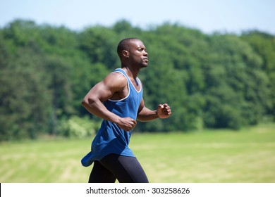 Side View Portrait Of A Fit Exercising Man Running Outside