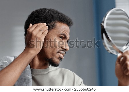 Similar – Image, Stock Photo Black man looking at camera through light filter