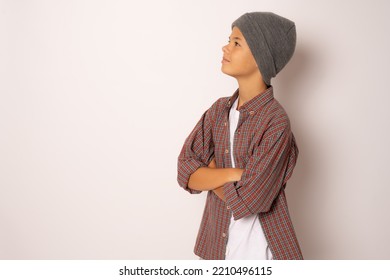 Side View Portrait Of Handsome Child Boy Wearing Winter Hat Standing With Arms Folded Isolated Over White Background.