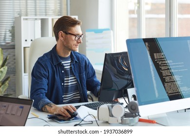 Side View Portrait Of Modern IT Developer Using Computer In Office While Working On VR Games And Software, Copy Space