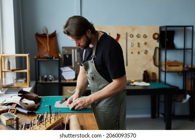 Side view portrait of modern male artisan working with leather in workshop studio, small business concept, copy space - Shutterstock ID 2060093570