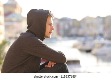 Side view portrait of a pensive teen boy contemplating a port on vacation - Shutterstock ID 1186376854