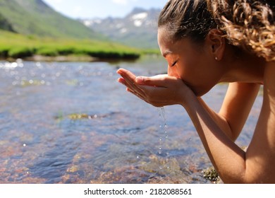 Side view portrait of a woman drinking raw water from river - Powered by Shutterstock