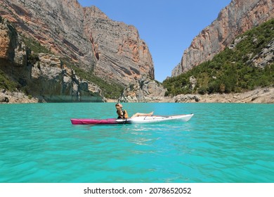 Side view portrait of a woman relaxing on kayak resting in a lake on summer vacation - Powered by Shutterstock