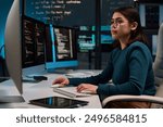 Side view portrait of young woman wearing glasses as cybersecurity engineer typing at computer keyboard and writing code copy space