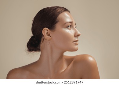 Side view portrait of a young woman with glowing, healthy skin in soft light. Ideal for beauty, skincare, and wellness campaigns. High-quality image for cosmetics or natural beauty promotions.