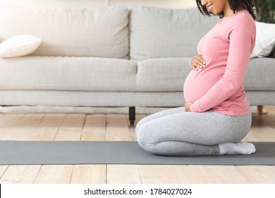 Side View Of Pregnant Black Woman Touching Her Belly, Getting Ready Before Morning Exercising, Home Interior, Free Space