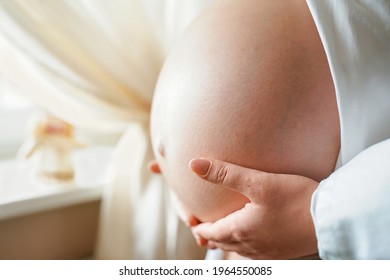 Side View Pregnant Woman With Big Belly Advanced Pregnancy In Hands.