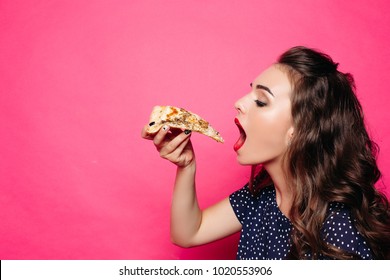Side view of pretty girl with long wavy hair eating delicious hot slice of pizza over bright magenta background. Isolate. Copyspace.