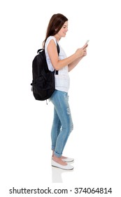 Side View Of Pretty University Student Texting On Smart Phone