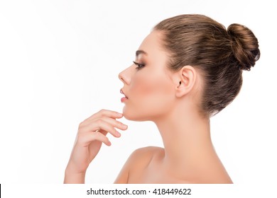Side view of pretty woman touching chin on white background