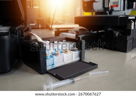 Side view of the printer and ink tank