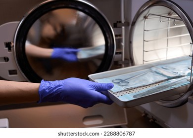 Side view the process of sterilizing medical instruments in an autoclave - Shutterstock ID 2288806787