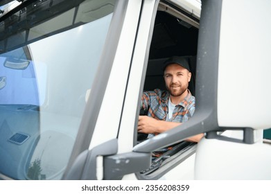 Side view of professional driver behind the wheel in truck's cabin