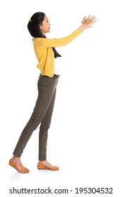 Side View Or Profile Of An Asian Girl Arms Up Like Holding Something, Full Length Standing Isolated On White Background.