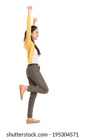 Side View Or Profile Of An Asian Girl Arms Up Happy Jumping Around, Full Length Standing Isolated On White Background.