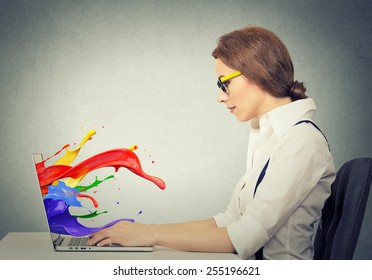 Side view profile attractive happy young business woman working on laptop computer colorful splashes coming out of screen liquid effect isolated grey wall background. Positive face expression vision  - Powered by Shutterstock