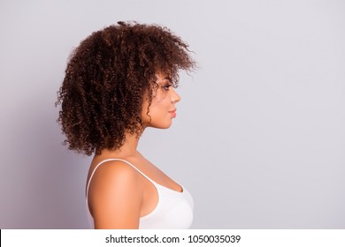 Side view, profile portrait with cope space, empty place of charming, sexy, pretty, attractive, nice girl with modern hairstyle, isolated on grey background, having plump, pout lips