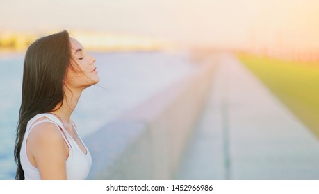 Side view profile portrait of a happy brunette woman relaxing breathing fresh air outdoors in summer Girl close eyes doing deep breath exercises. Positive emotion success, peace of mind, zen concept - Shutterstock ID 1452966986
