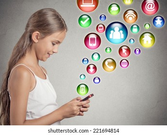 Side View Profile Teenager Girl Using Texting Playing On Smartphone With Social Media Mobile Phone Application Symbols Icons Coming Flying Out Of Cellphone Isolated Grey Wall Background. Data Plan