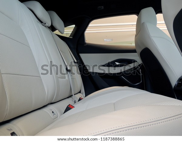 Side view of rear seats in car interior with\
black and white leather\
upholstery