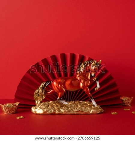 Side view red backdrop gold dragon horse statue coins fan symbolizing Chinese New Year celebration greeting prosperity luck wealth