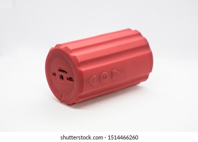 A Side View Of A Red Color Bluetooth Speaker.