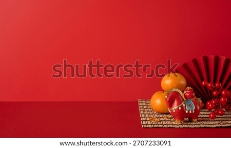 Side view of a red festive setting featuring Chinese New Year lanterns, oranges, and a decorative horse statue on a bamboo mat, symbolizing luck, prosperity, and festive greetings