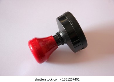 Side View Of The Red Handle Rubber Stamp Isolated On A White Background