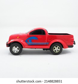 Side View Of A Red Pickup Truck Toy Isolated In A White Background